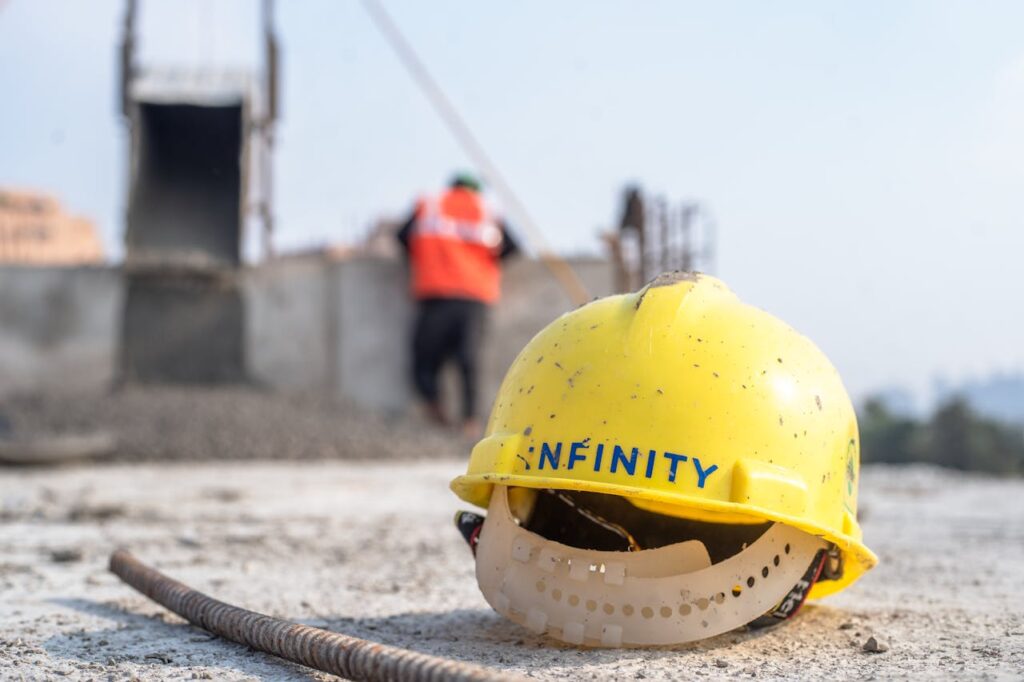 Close-up of a yellow safety helmet on a construction site in Delhi.