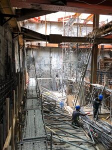 Construction site with scaffolding and workers in Taiwan, showcasing urban development.